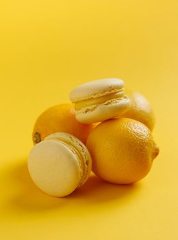 Lemon macaroons on a yellow background vertical