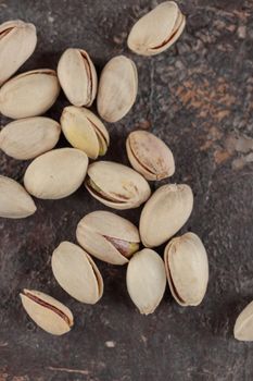 Organic pistachios on a dark background macro