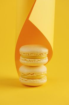 Lemon macaroons on a yellow background vertical