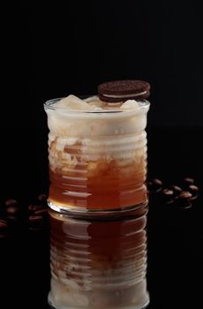 Cocktail in a glass on a black background vertical