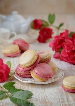 Colorful pink and yellow macaroons on the table