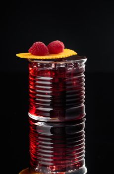Cocktail in a glass on a black background vertical