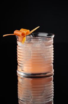 Cocktail in a glass on a black background vertical