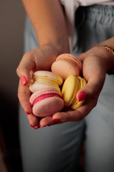 French macaroons in woman's hand
