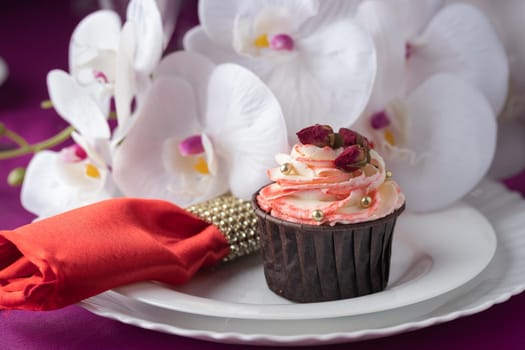Pink and purple decoration and cupcakes on the table