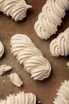 Close up sweet meringue on a brown background top view