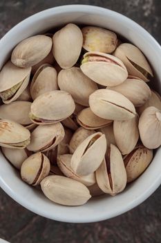 Organic pistachios on a dark background macro
