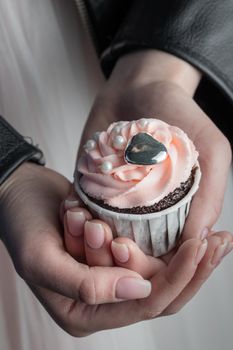 Grunge style cupcakes with black and pink cream vertical