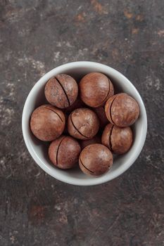 Macadamia nuts on a grey background top view
