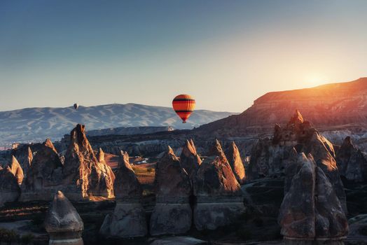 Amazing sunset over Cappadocia. Beautiful color balloons Turkey