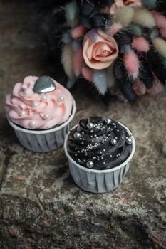 Grunge style cupcakes with black and pink cream vertical