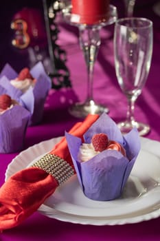 Pink and purple decoration and cupcakes on the table