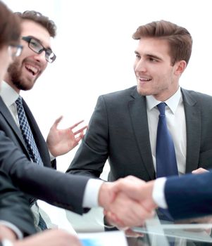 handshake business colleagues in office