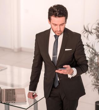 confident businessman standing in the office. the concept of communication