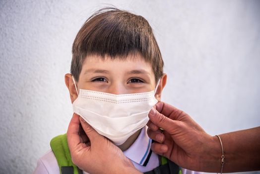 Closeup Kid face wearing protective face mask for pollution or virus, Cropped shot of school boy wearing protection mask against pm 2.5 air pollution
