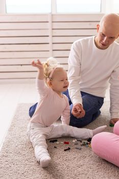 Cochlear implant for baby. Deaf child with hearing aid plays in living room