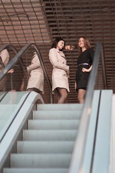 employees standing on the steps of the escalator in the business center. photo with copy space