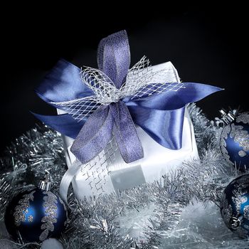 closeup .Christmas gift and blue Christmas balls on a festive white background .Christmas card
