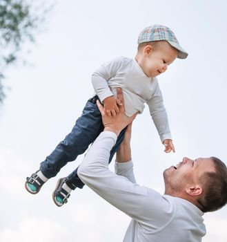 father and son on a background of blue sky. the concept of fatherhood