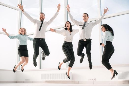 very happy business team rejoices in the spacious office. winning concept