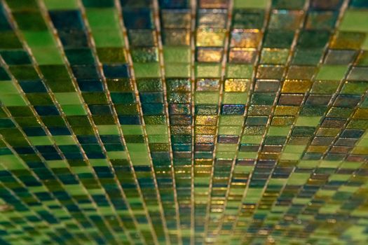 Close up modern green mosaic tiles on wall. Sauna room interior design with mosaic. Ceramic tiles mosaic. Close up.