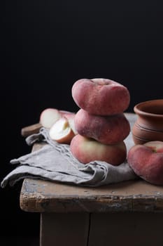 Peaches on an old rustic table Vertical