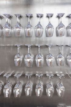 Wine glasses hanging on wall in wine shop