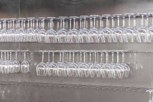 Wine glasses hanging on wall in wine shop