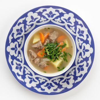 Oriental Uzbek cuisine dish in traditional plate