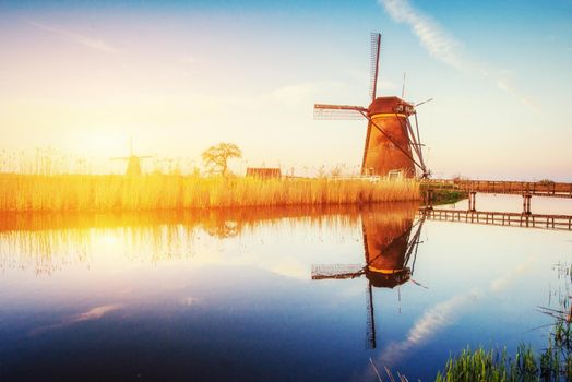 Dutch mill at sunset from the canal in Rotterdam. Holland. Netherlands