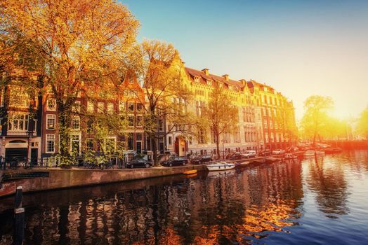 Fantastic sunset that shines on buildings and reflected in the water. Amsterdam is the capital and most populous city in Netherlands.