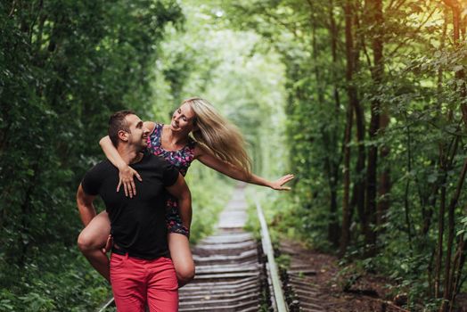Loving couple in love tunnel iron road.
