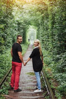 Loving couple on the iron road. Ukraine. Klevan