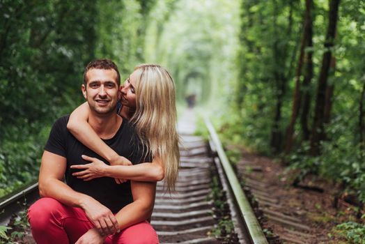 Loving couple in love tunnel iron road.