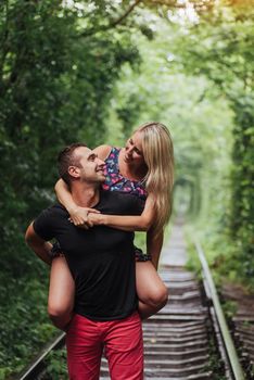 Loving couple in love tunnel iron road.