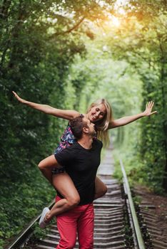 Loving couple in love tunnel iron road.