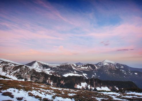 Colorful spring sunset over the mountain ranges in the national park Carpathians. Ukraine, Europe.
