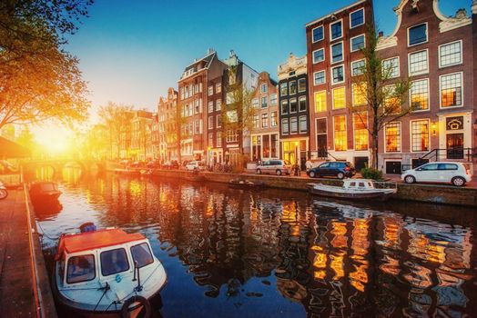 Amsterdam canal. Fantastic sunset is reflected in the water.