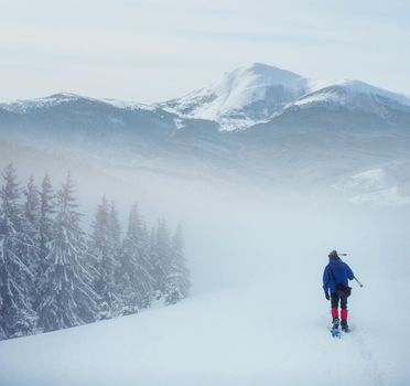 hiker with snowshoes in winter. Carpathian, Ukraine Europe