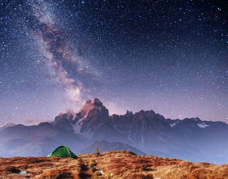 Tent green spread out on the pass Goulet. Fantastic starry sky. Georgia, Svaneti. Europe. Caucasus Mountains