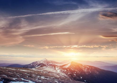 Colorful spring sunset over the mountain ranges in the national park Carpathians. Ukraine, Europe.