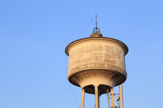 old water tower tank with blue sky