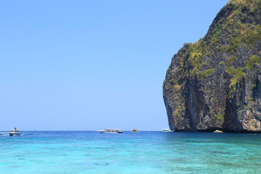 Maya Bay lagoon with Motor boat on turquoise water, Phi Phi island, Thailand