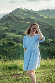 Woman in blue dress in Altai mountain, beauty summer landcape, travel, lesure concept