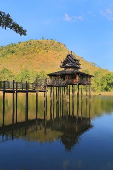 wood Thai pavilion reflect in pool with mountain and blue sky