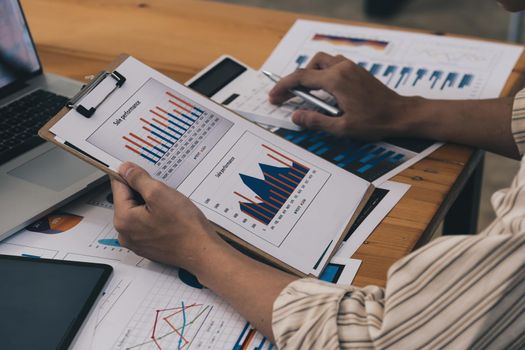 Close-up of a businessman using a calculator to audit the company's budget. Tax information is calculated by accountants.