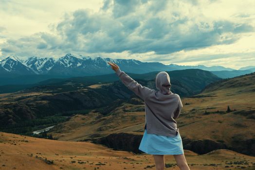 Woman in blue dress in summer Altai mountains in Kurai steppe