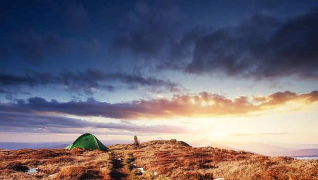 The tent is made up of green in the Carpathians. Spring mountain landscape. Ukraine. Europe.