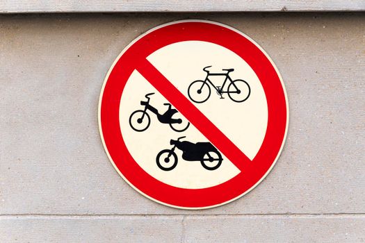 Prohibition sign for bikes, bicycles, motorbikes and motos on a wall in the street