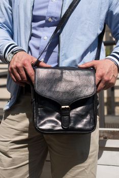 close-up photo of black leather bag . outdoors photo